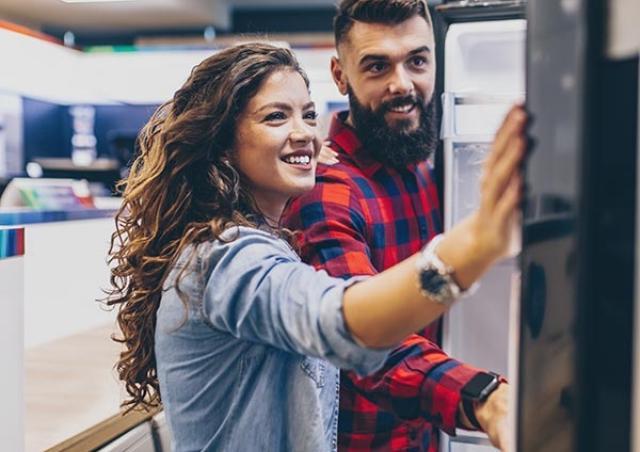 Couple looking at fridge